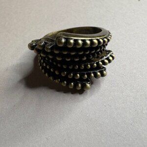 vintage-style statement ring featuring a bold, sculptural design